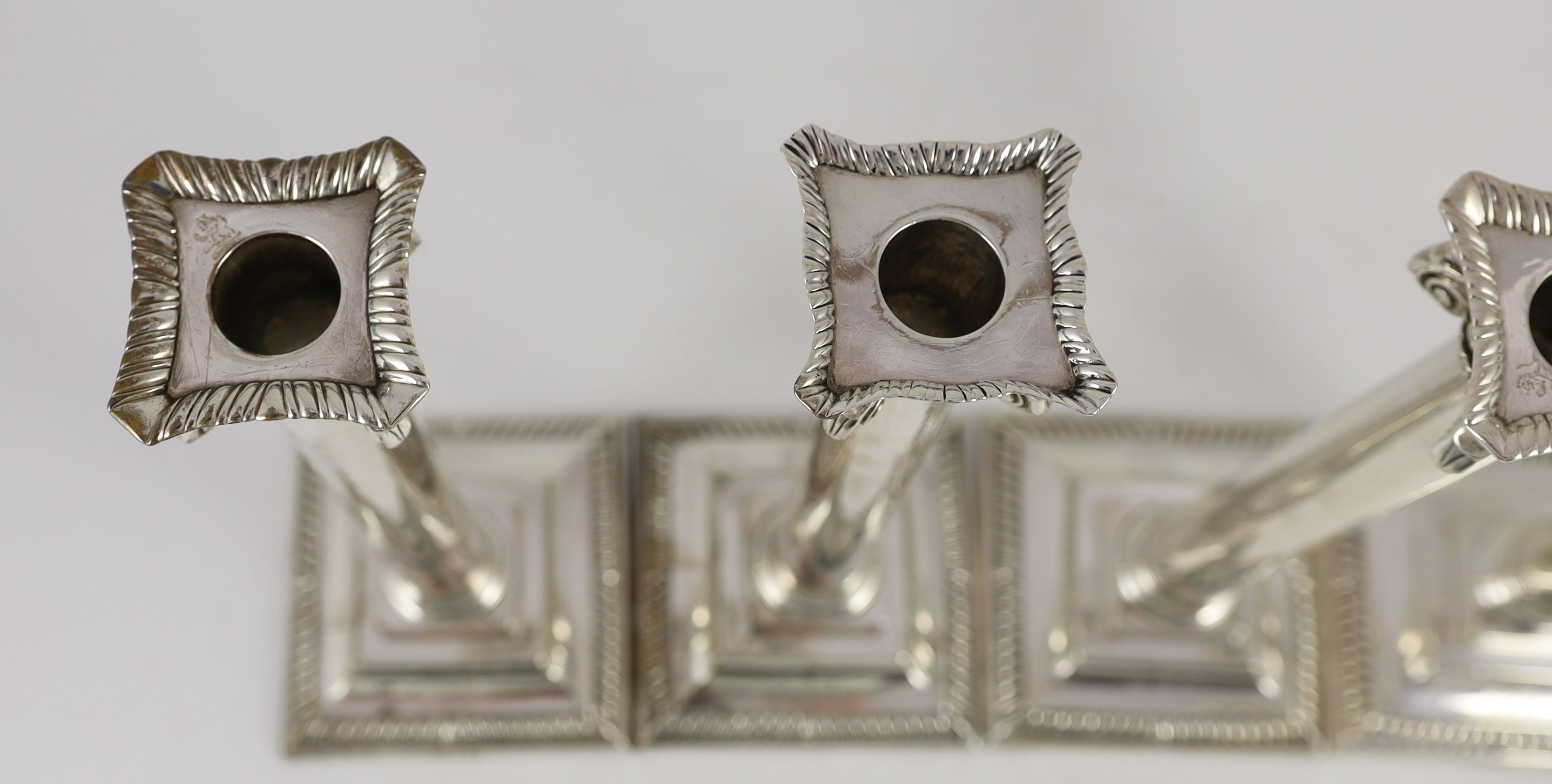 A set of three George III Corinthian silver ionic column candlesticks, by Thomas Shephard? London, 1795 and one other matched candlestick, Smith & Sharp, London, 1786